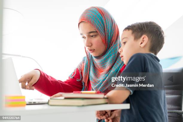 helping little boy in studying at home - two young arabic children only indoor portrait stock pictures, royalty-free photos & images