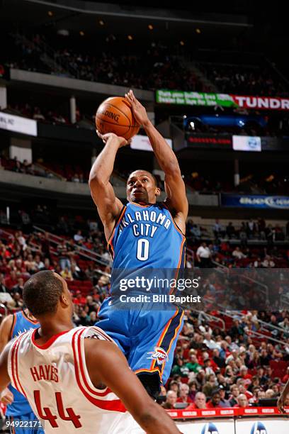 Russell Westbrook of the Oklahoma City Thunder shoots the ball over Chuck Hayes of the Houston Rockets on December 19, 2009 at the Toyota Center in...