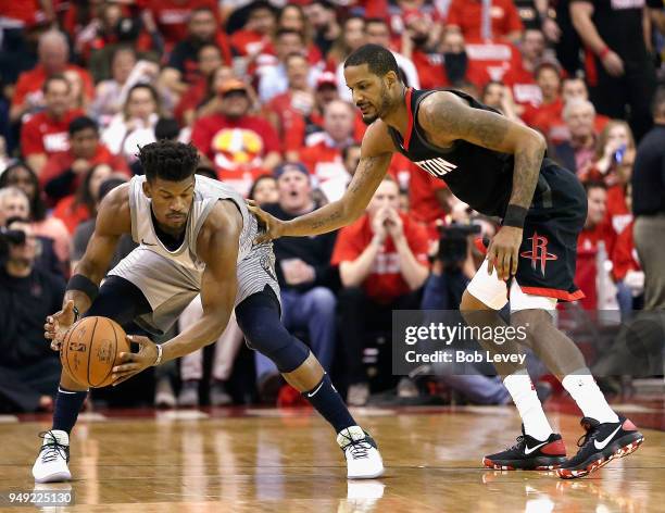 Jimmy Butler of the Minnesota Timberwolves is defended by Trevor Ariza of the Houston Rockets during Game Two of the first round of the Western...