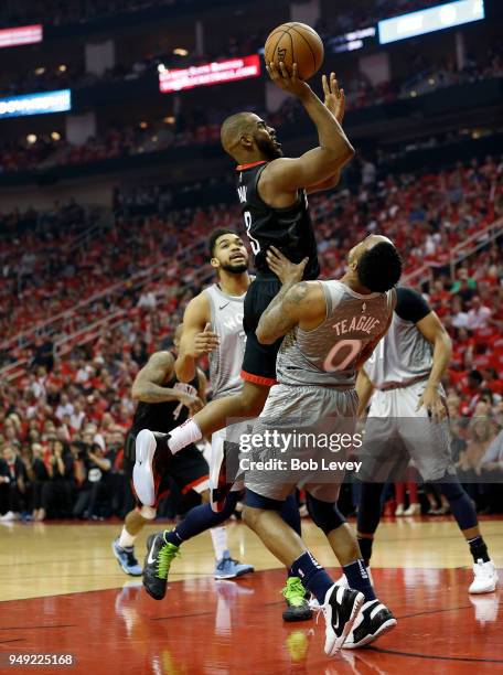 Chris Paul of the Houston Rockets drives over Jeff Teague of the Minnesota Timberwolves during Game Two of the first round of the Western Conference...