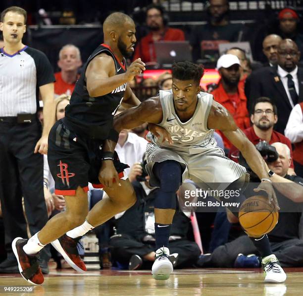 Jimmy Butler of the Minnesota Timberwolves backs in on Chris Paul of the Houston Rockets during Game Two of the first round of the Western Conference...