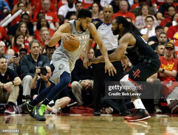 Karl-Anthony Towns of the Minnesota Timberwolves drives on Nene Hilario of the Houston Rockets during Game Two of the first round of the Western...