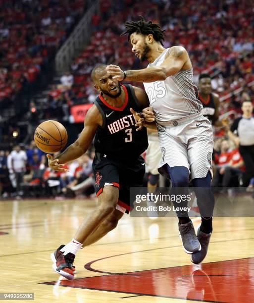 Chris Paul of the Houston Rockets drives on Derrick Rose of the Minnesota Timberwolves during Game Two of the first round of the Western Conference...