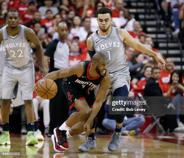 Chris Paul of the Houston Rockets dribbles around Tyus Jones of the Minnesota Timberwolves during Game Two of the first round of the Western...