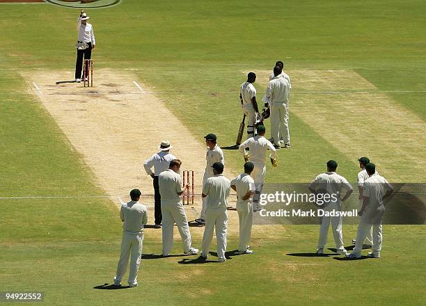 Umpire Billy Bowden raises his finger for the second time after getting the signal from the Third Umpire to dismiss Kemar Roach of the West Indies...