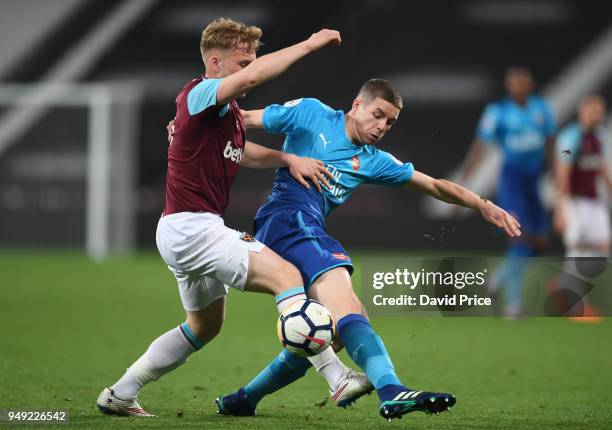 Charlie gilmour of Arsenal challenges Anthony Scully of West Ham during the match between West Ham United and Arsenal at London Stadium on April 20,...