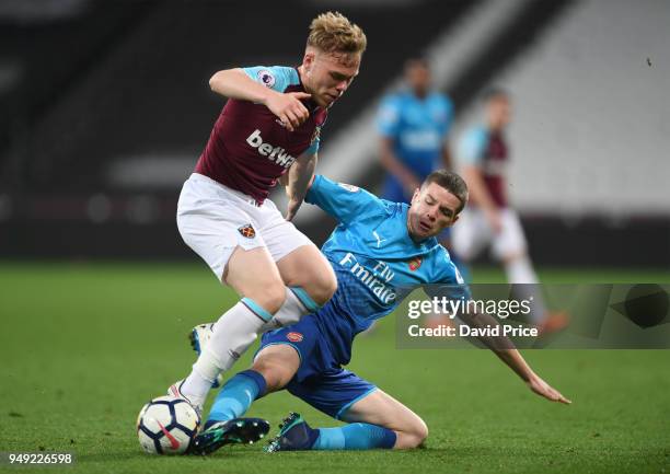 Charlie gilmour of Arsenal challenges Anthony Scully of West Ham during the match between West Ham United and Arsenal at London Stadium on April 20,...