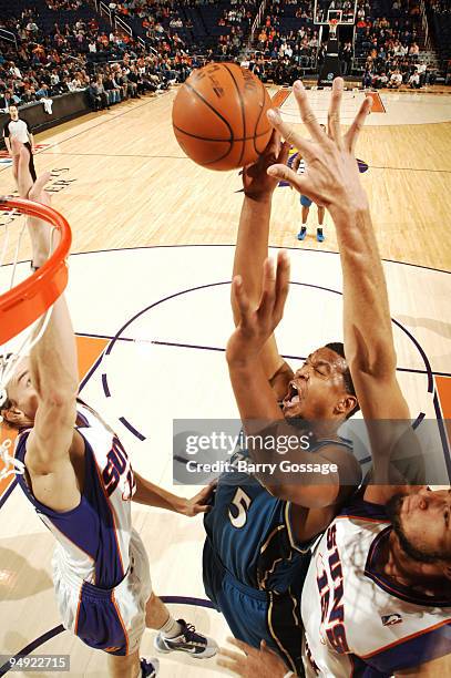 Dominic McGuire of the Washington Wizards tries to get a shot past the block of Louis Amundson and Robin Lopez of the Phoenix Suns in an NBA Game...