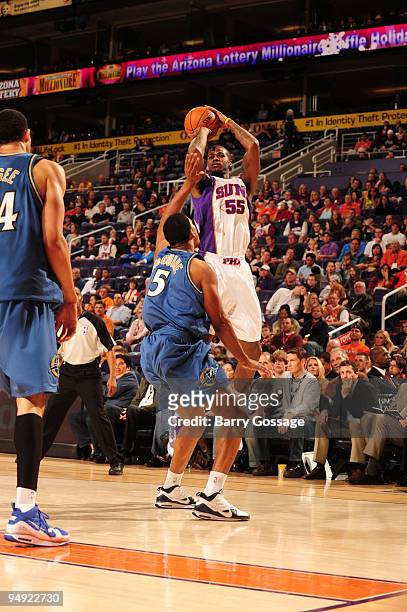 Earl Clark of the Phoenix Suns puts a shot up over Dominic McGuire of the Washington Wizards in an NBA Game played on December 19, 2009 at U.S....