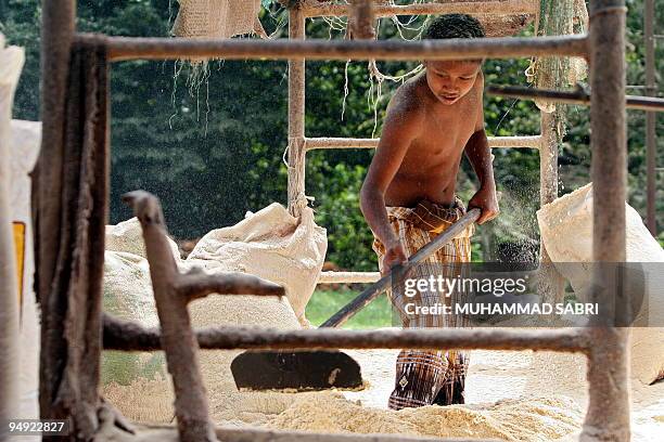 Young Thai man works at a rubber tree factory in Thailand's southern province of Yala on December 19, 2009. Thai consumer confidence rose to a...