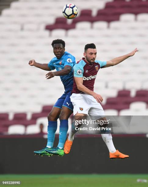 Tolaji Bola of Arsenal heads the ball under pressure from Sead Haksabanovic of West Ham during the match between West Ham United and Arsenal at...