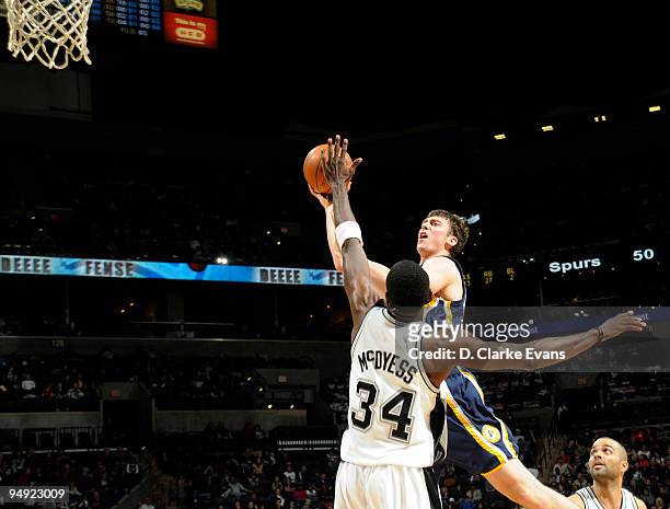 Tyler Hansbrough of the Indiana Pacers shoots against Antonio McDyess of the San Antonio Spurs on December 19, 2009 at the AT&T Center in San...