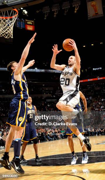 Manu Ginobili of the San Antonio Spurs shoots against Tyler Hansbrough of the Indiana Pacers on December 19, 2009 at the AT&T Center in San Antonio,...