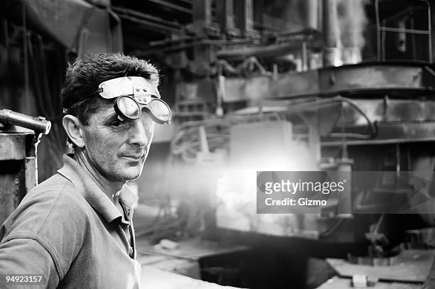 male steel mill worker with specialist glasses  - steel factory stockfoto's en -beelden