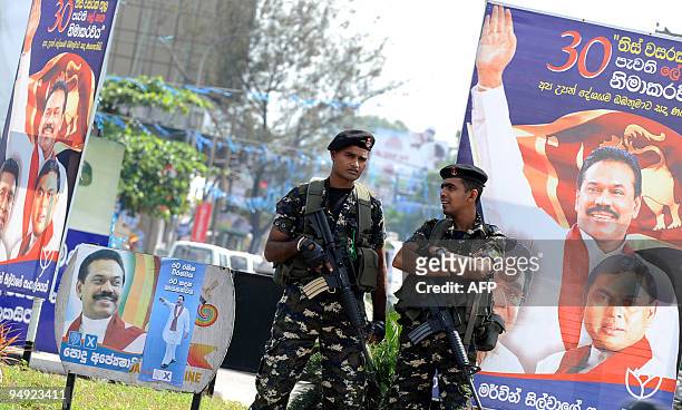 Sri Lankan special forces commandos stands guard near campaign posters of Sri Lankan President Mahinda Rajapakse in Colombo on December 20, 2009. Sri...