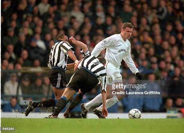 Mark Viduka of Leeds United evades the challenges from Alain Goma and Robert Lee of Newcastle United during the FA Carling Premiership match played...