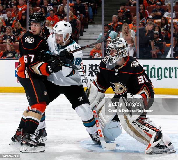 Mikkel Boedker of the San Jose Sharks battles for position against Rickard Rakell and John Gibson of the Anaheim Ducks in Game Two of the Western...