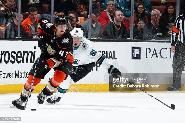 Hampus Lindholm of the Anaheim Ducks skates with the puck with pressure from Justin Braun of the San Jose Sharks in Game Two of the Western...