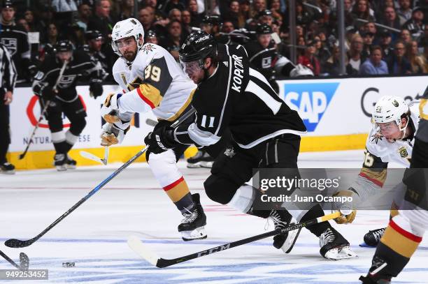 Anze Kopitar of the Los Angeles Kings skates with the puck against Alex Tuch and Erik Haula of the Vegas Golden Knights in Game Four of the Western...