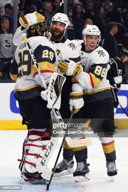 Deryk Engelland and Nate Schmidt of the Vegas Golden Knights congratulate Marc-Andre Fleury of the Vegas Golden Knights after a 1-0 shutout win over...