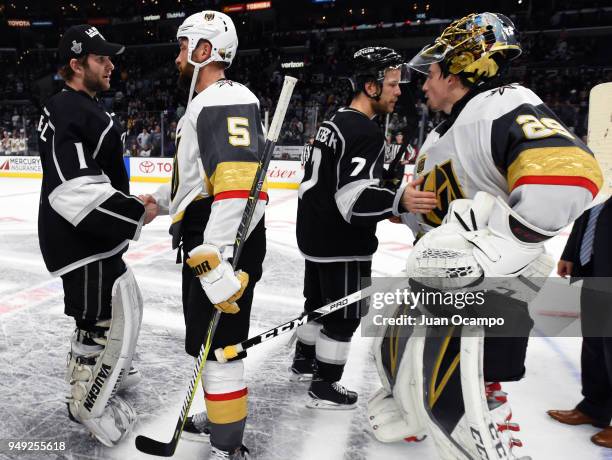 Oscar Fantenberg and Jack Campbell of the Los Angeles Kings shake hands with Deryk Engelland and Marc-Andre Fleury of the Vegas Golden Knights...