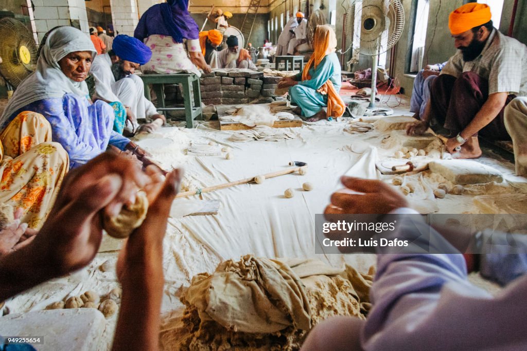 Sikh pilgrims preparing food in the Langar community kitchen of the Golden Temple