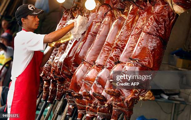 Roasted pigs are displayed at a store in the Manila suburbs on December 20, 2009 ahead of Christmas Day. "Lechon", or roasted pig, has always been a...