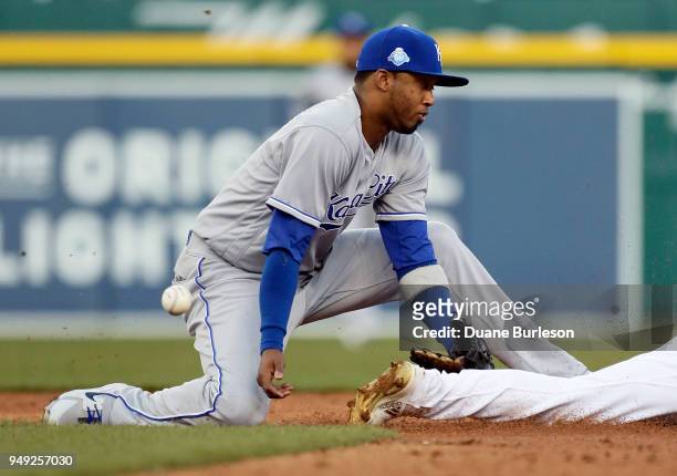 Shortstop Alcides Escobar of the Kansas City Royals can't handle the pickoff throw as Jose Iglesias of the Detroit Tigers steals second base during...