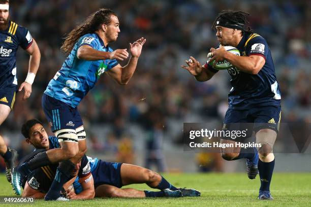 Aki Seiuli of the Highlanders attempts to beat the tackle of Kara Pryor of the Blues during the round 10 Super Rugby match between the Blues and the...