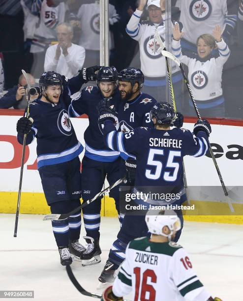 Andrew Copp, Dustin Byfuglien, Mark Scheifele and Joel Armia of the Winnipeg Jets celebrate Armia's goal in Game Five of the Western Conference First...