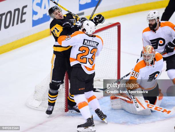Philadelphia Flyers defenseman Brandon Manning and Pittsburgh Penguins center Evgeni Malkin battle in front of Philadelphia Flyers goaltender Michal...