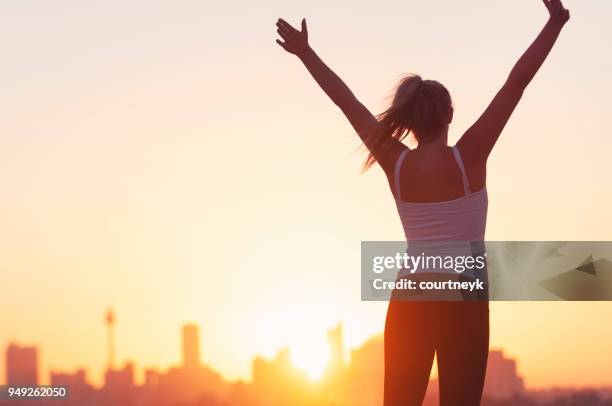 sport women celebrating with arms raised. - runner sunrise stock pictures, royalty-free photos & images