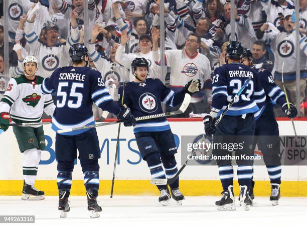 Mark Scheifele, Andrew Copp, Dustin Byfuglien and Joel Armia of the Winnipeg Jets celebrate a first period goal against the Minnesota Wild in Game...