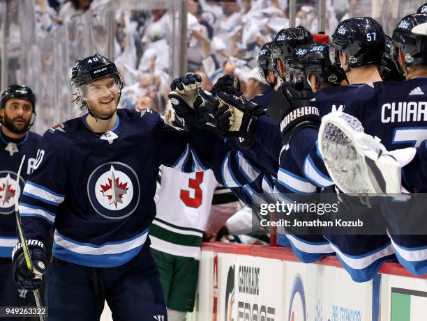 Joel Armia of the Winnipeg Jets celebrates his first period goal against the Minnesota Wild with teammates at the bench in Game Five of the Western...