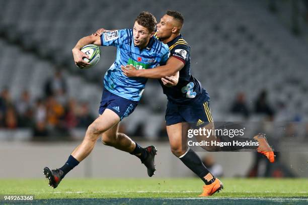 Matt Duffie of the Blues is tackled by Tevita Li of the Highlanders during the round 10 Super Rugby match between the Blues and the Highlanders at...