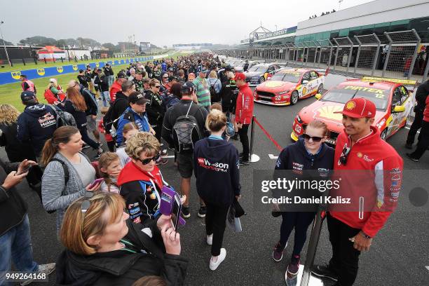 Fabian Coulthard driver of the Shell V-Power Racing Team Ford Falcon FGX poses for a photo with a fan during the Supercars Phillip Island 500 at...