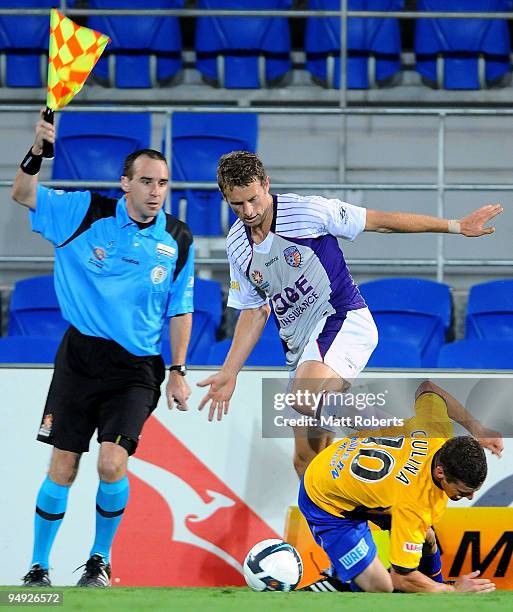 Jamie Coyne of Glory cotests the ball with Jason Culina of United during the round 20 A-League match between Gold Coast United and the Perth Glory at...