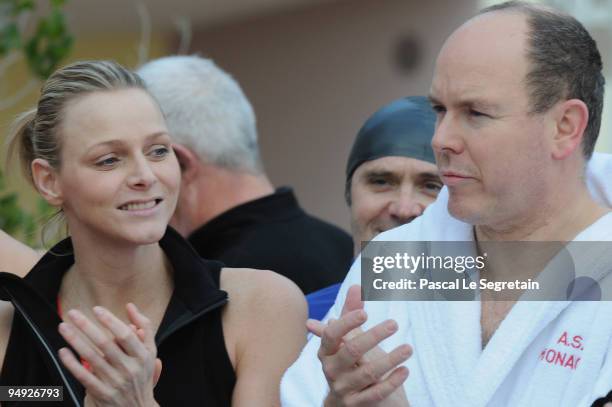 Prince Albert II of Monaco and Charlene Wittstock walk on the beach after the Annual Charity Christmas Swim for TATSA Association on December 20,...