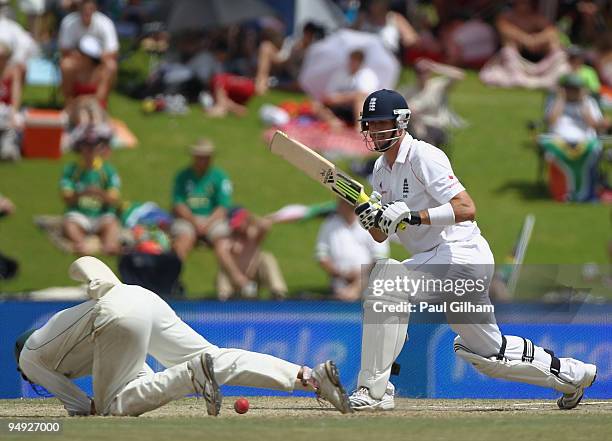 Kevin Pietersen of England hits out and Hashim Amla of South Africa tries in vain to make a catch during day five of the first test match between...