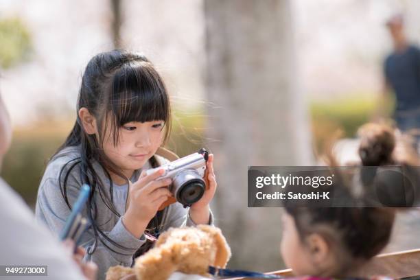 little girl taking picture of her sister - digital camera stock pictures, royalty-free photos & images