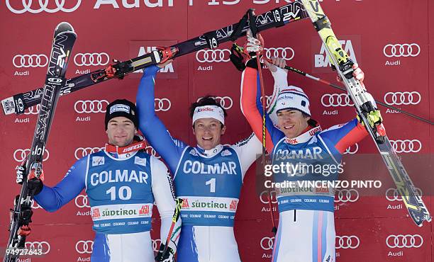 Second placed Italy's Davide Simoncelli, winner Italy's Massimiliano Blardone and third placed France's Cyprien Richard celebrate on the podium of...