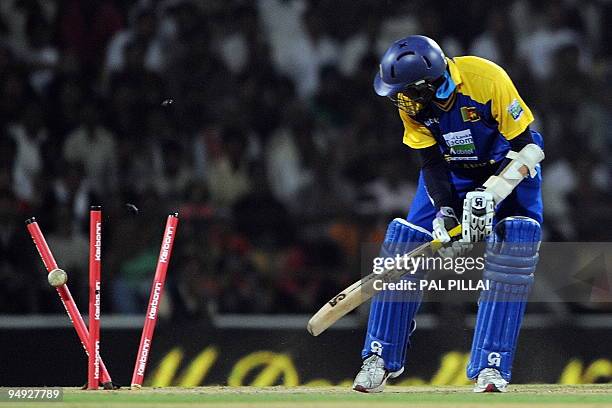 Sri Lankan cricketer Tillakaratne Dilshan watches the stump as he gets clean bold on India's Ashish Nehra's bowling on the second ODI cricket match...