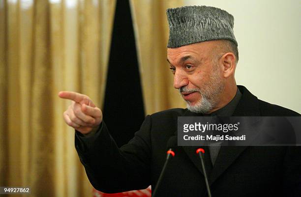 Afghanistan's President Hamid Karzai attends a joint press conference with Belgian Prime Minister Yves Leterme on December 20, 2009 in Kabul,...