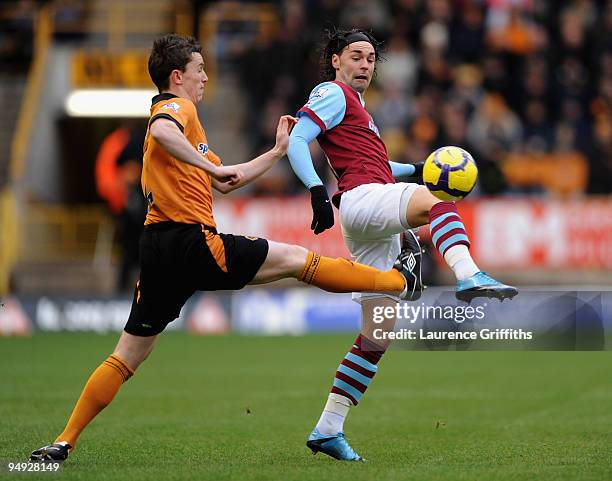 Kevin Foley of Wolves battles with Chris Eagles of Burnley during the Barclays Premier League match between Wolverhampton Wanderers and Burnley at...