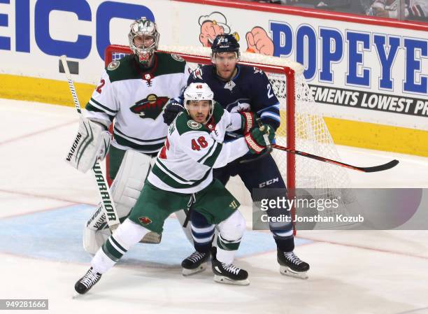Goaltender Alex Stalock, Jared Spurgeon of the Minnesota Wild and Paul Stastny of the Winnipeg Jets keep an eye on the play during second period...