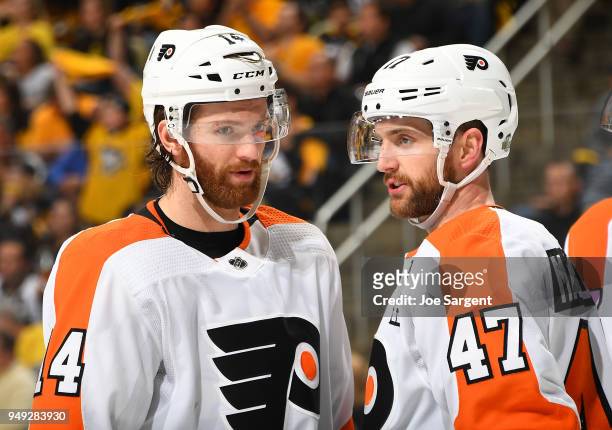 Sean Couturier talks with Andrew MacDonald of the Philadelphia Flyers during the third period against the Pittsburgh Penguins in Game Five of the...