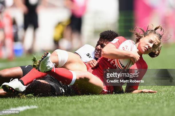 Caroline Crossley of Canada is tackled by Miriama Naiobasali of Fiji on day one of the HSBC Women's Rugby Sevens Kitakyushu Pool match between Canada...