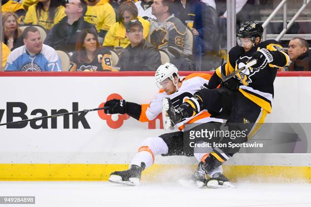 Philadelphia Flyers left wing Michael Raffl and Pittsburgh Penguins defenseman Kris Letang collide during the third period. The Philadelphia Flyers...