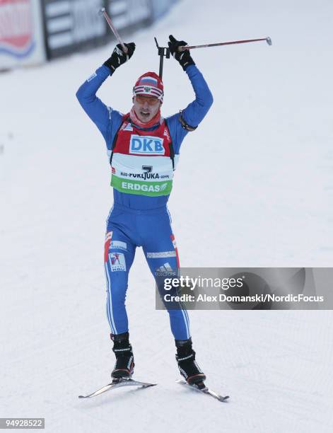 Evgeny Ustyugov of Russia celebrates on the finish line after winning the Men's 10km Pursuit in the e.on Ruhrgas IBU Biathlon World Cup on December...