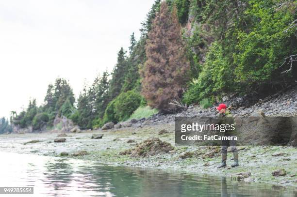 man fishing with rod and reel in alaska - kachemak bay stock pictures, royalty-free photos & images